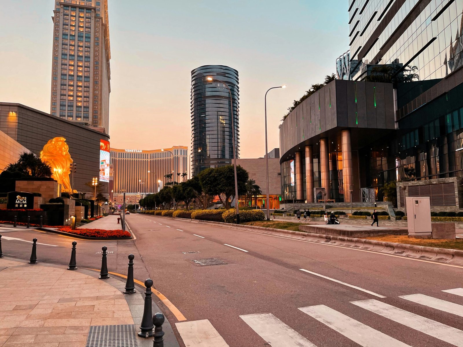 a city street with tall buildings in the background